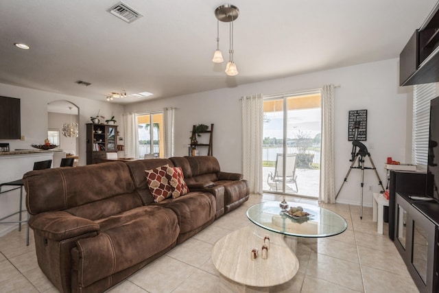 living room featuring plenty of natural light and light tile patterned floors