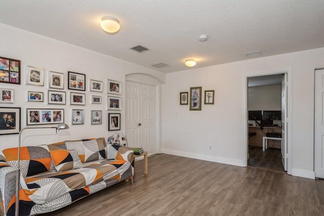 living room featuring hardwood / wood-style floors and a textured ceiling