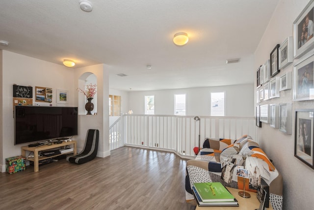 interior space featuring a textured ceiling and hardwood / wood-style floors