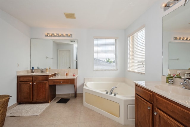 bathroom with vanity, tile patterned floors, and a tub