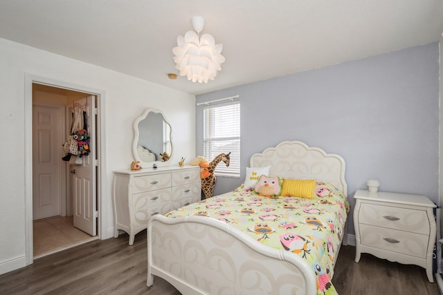 bedroom with dark wood-type flooring