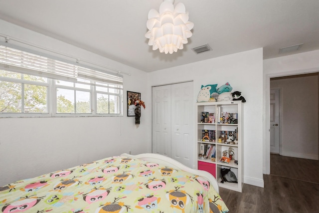 bedroom featuring a closet and dark hardwood / wood-style flooring