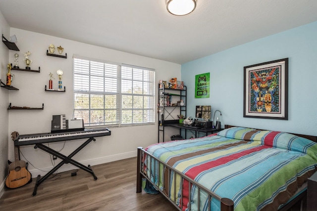 bedroom with dark hardwood / wood-style floors