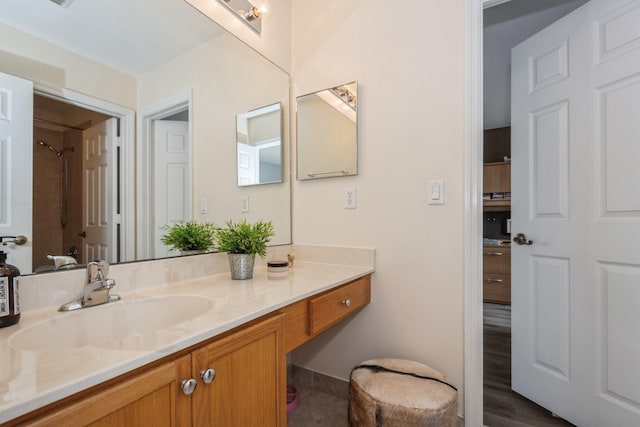 bathroom with a shower and vanity