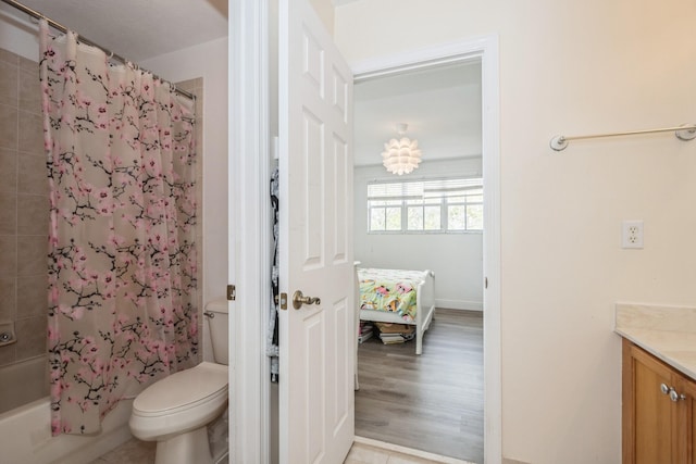 full bathroom featuring toilet, vanity, wood-type flooring, and shower / bath combo