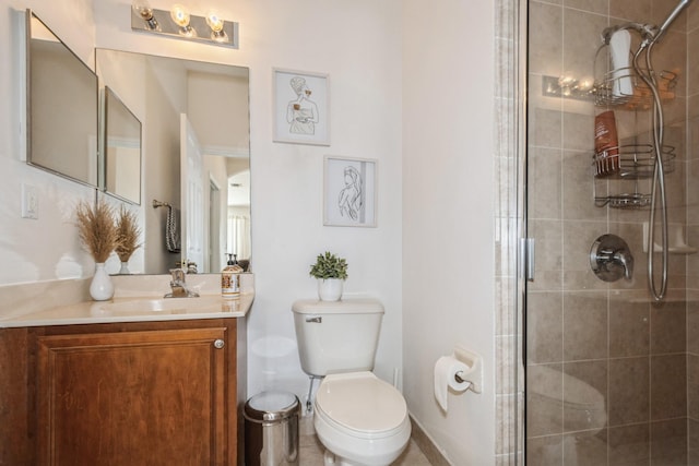 bathroom with toilet, vanity, and a shower with shower door