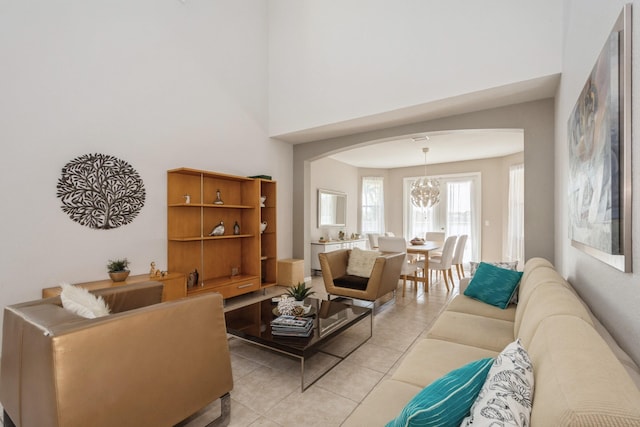 living room featuring light tile patterned floors and a chandelier