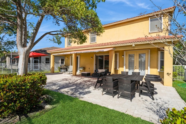 back of house with french doors and a patio