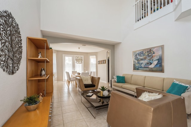 living room featuring a notable chandelier and light tile patterned flooring