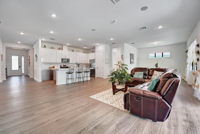 living room with light hardwood / wood-style flooring