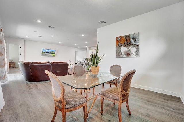 dining room with light wood-style floors, recessed lighting, and visible vents