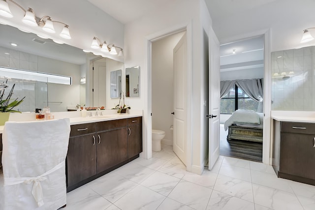 full bathroom with toilet, marble finish floor, visible vents, and vanity