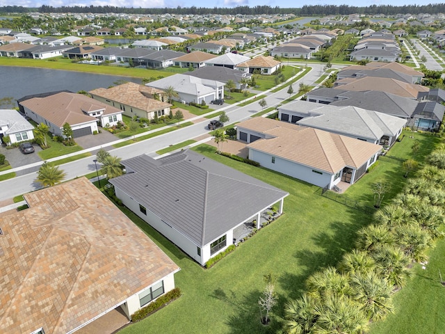 bird's eye view featuring a water view and a residential view