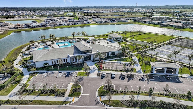 drone / aerial view with a residential view and a water view