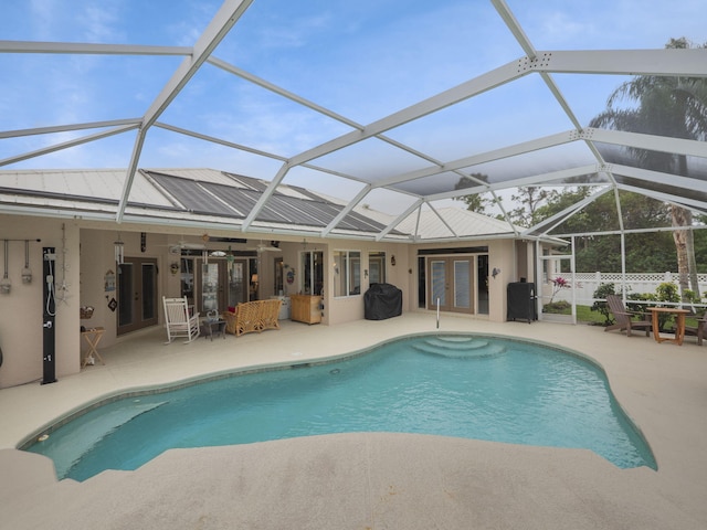 view of pool featuring area for grilling, a lanai, a patio area, and french doors