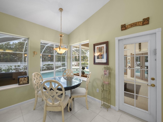 dining area featuring tile patterned flooring and vaulted ceiling