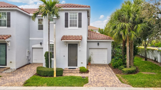 mediterranean / spanish-style home with a garage