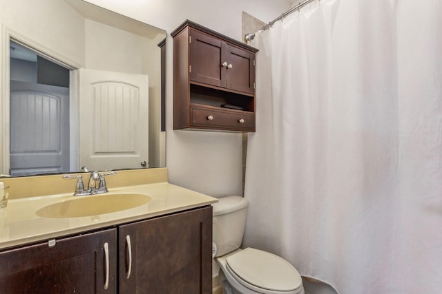 bathroom with toilet and vanity