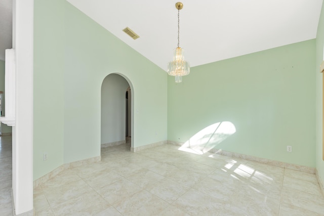 unfurnished room with lofted ceiling and an inviting chandelier