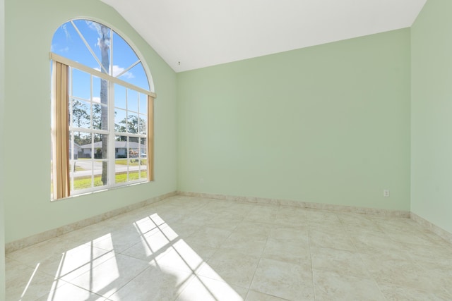 tiled empty room with vaulted ceiling