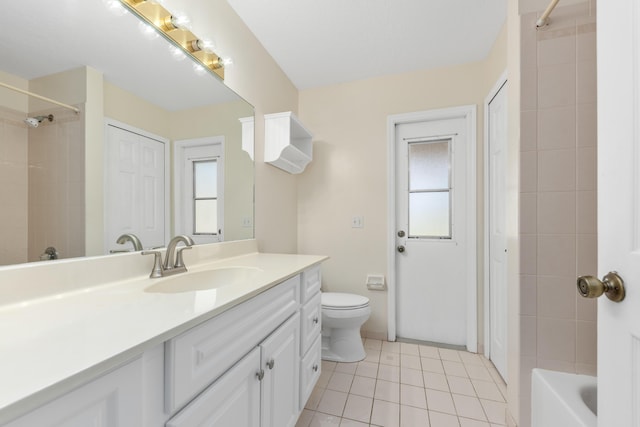 full bathroom featuring tile patterned flooring, toilet, vanity, and a healthy amount of sunlight