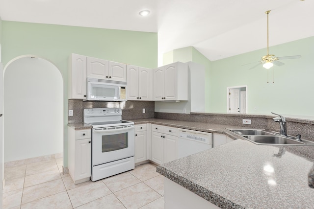 kitchen with tasteful backsplash, white cabinets, sink, and white appliances