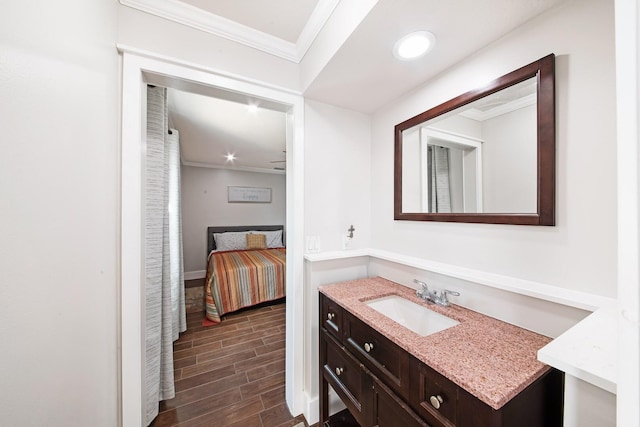 bathroom with ornamental molding and vanity