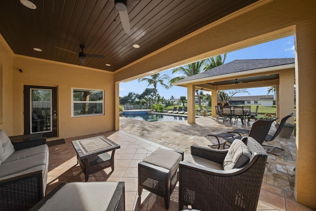 view of patio / terrace with a water view, outdoor lounge area, and ceiling fan