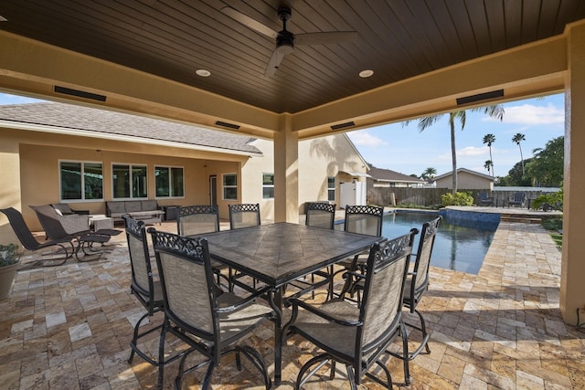 view of patio featuring a fenced in pool, outdoor lounge area, and ceiling fan