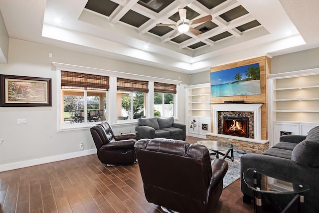 living room with a towering ceiling, dark hardwood / wood-style floors, coffered ceiling, a fireplace, and beamed ceiling