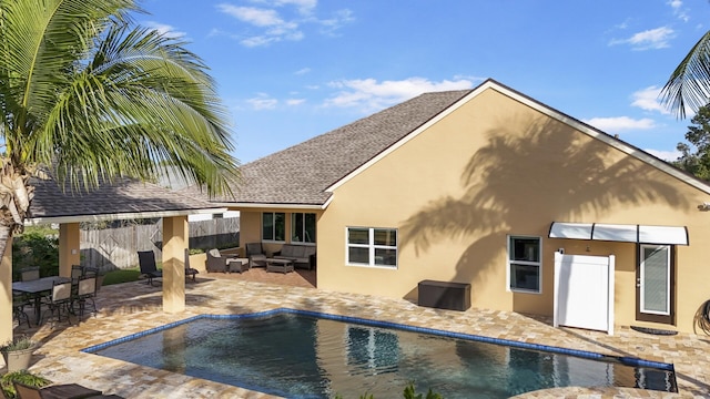 back of house featuring outdoor lounge area and a patio area