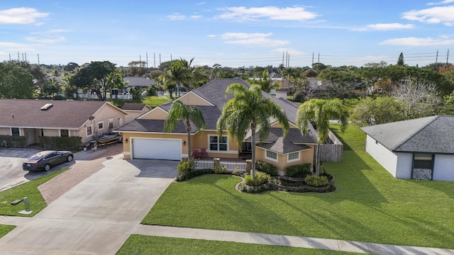 view of front of property featuring a garage and a front yard