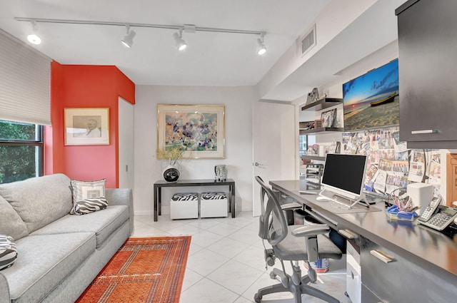 tiled office featuring track lighting