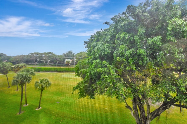 view of property's community featuring a rural view and a lawn