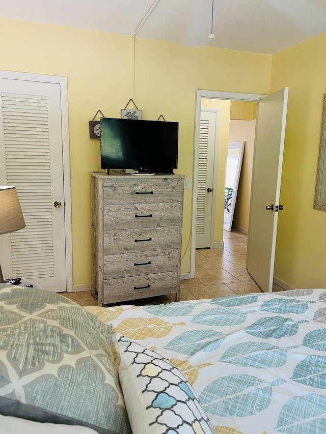 tiled bedroom with a closet