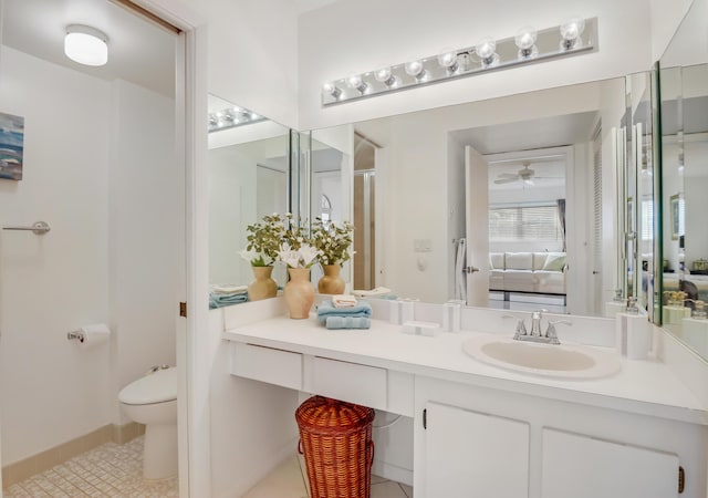 bathroom with toilet, tile patterned floors, and vanity