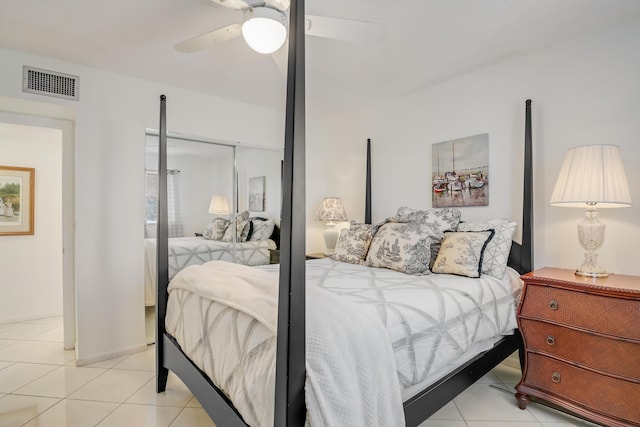 tiled bedroom featuring ceiling fan