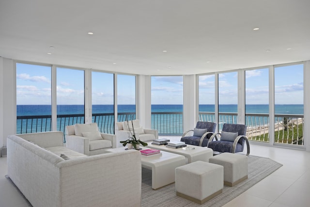 living room featuring floor to ceiling windows and a water view