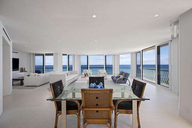 dining room featuring a water view and floor to ceiling windows