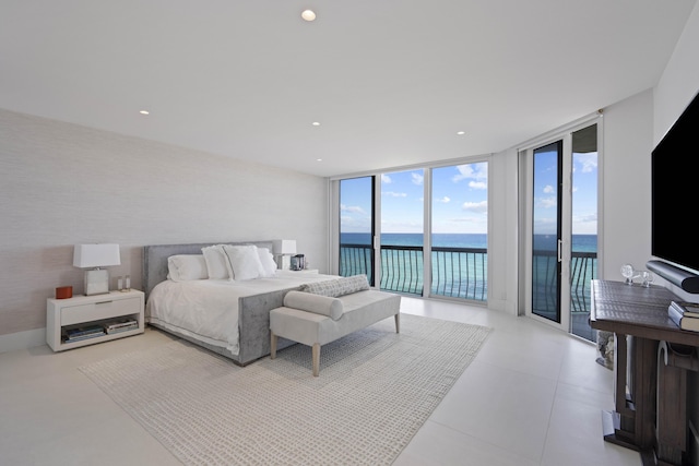 bedroom with expansive windows and access to outside