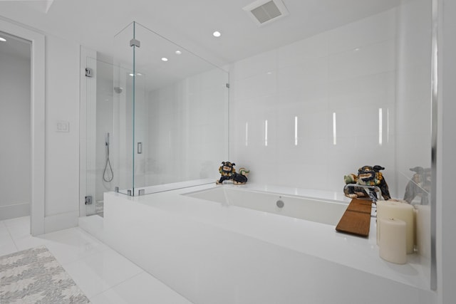 bathroom featuring separate shower and tub and tile patterned flooring