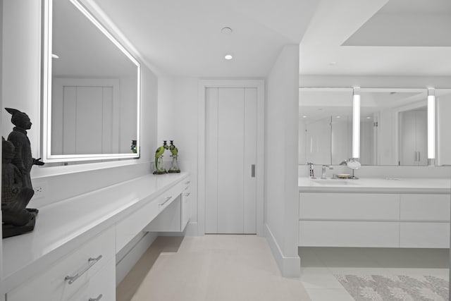 bathroom with an enclosed shower, vanity, and tile patterned flooring