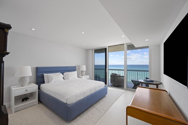 bedroom featuring a wall of windows and access to exterior