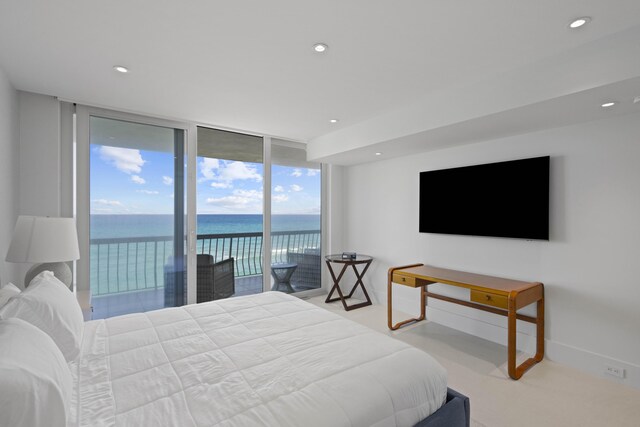 bedroom featuring expansive windows and access to outside