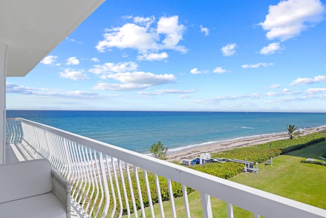 balcony featuring a water view and a view of the beach