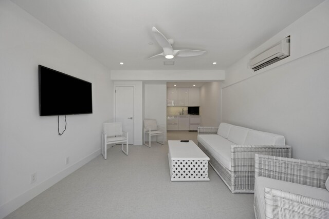 living room featuring ceiling fan, light colored carpet, and a wall mounted AC