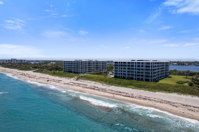 birds eye view of property with a water view and a view of the beach