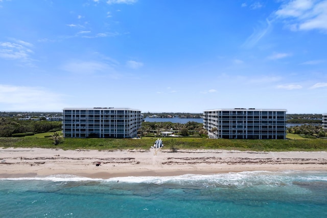 drone / aerial view with a water view and a beach view