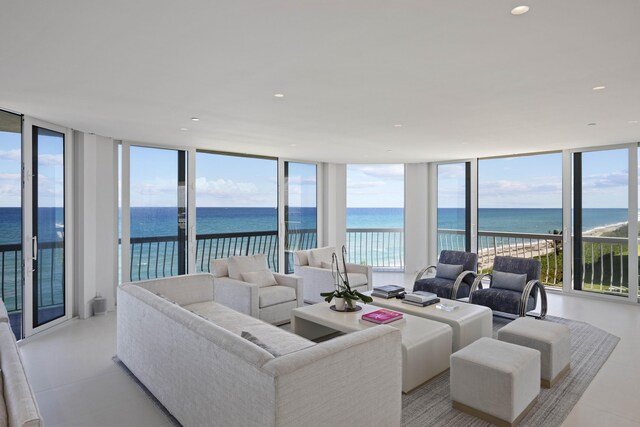 living room with a water view and expansive windows