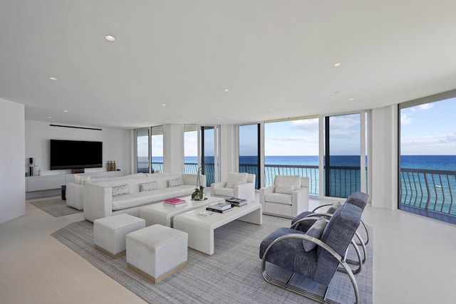 living room featuring expansive windows and a water view